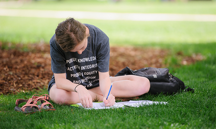 Student studying on the Quad